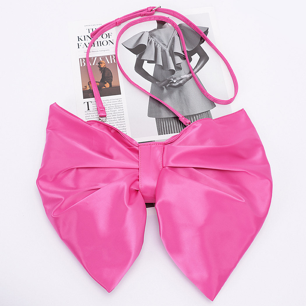 hot pink satin oversized bow-shaped purse with matching crossbody strap