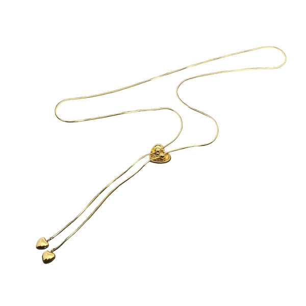 18k gold plated stainless steel shiny bolo tie style necklace with puffy heart charm, snake chain, and matching heart-shaped tips. Shown flat from back