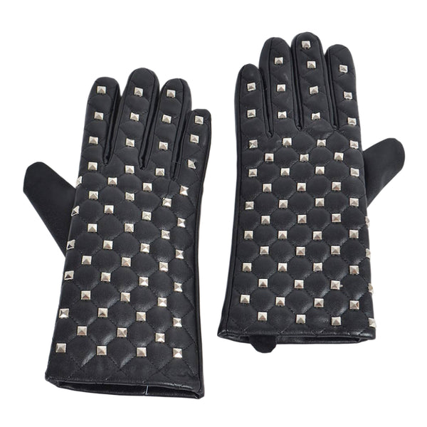 black faux leather wrist length gloves with quilted stitching and tiny silver metal pyramid studs. Shown flat