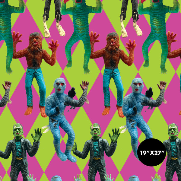 Rectangular wrapping paper sheets with neon pink and green diamond pattern and photorealistic rubber monster toys in foreground. Close up of pattern