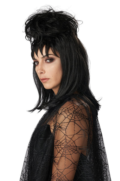 model dressed as Lydia Deetz from Beetlejuice wearing black shoulder length layered wig with spiky bangs and voluminous birds nest updo wearing black lace dress. Shown from side