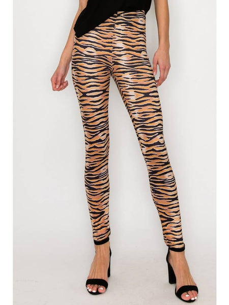 model wearing high-waisted, full-length brushed fiber knit leggings with a black and orange tiger stripe pattern. Shown from front