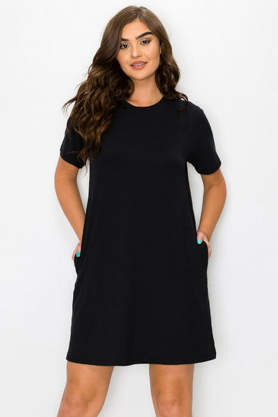 model wearing black brushed fiber knit short sleeve knee length dress with side seam pockets. Shown from front