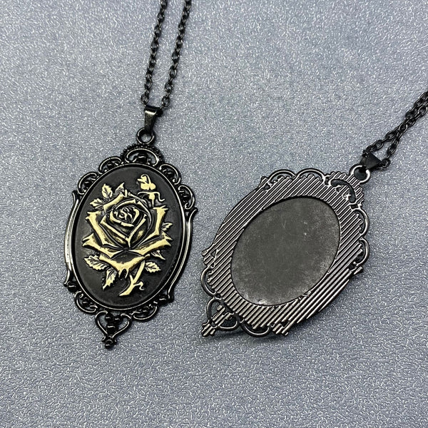 Black and white rose cameo pendant on black link chain necklace shown in close up of both front and back of pendant