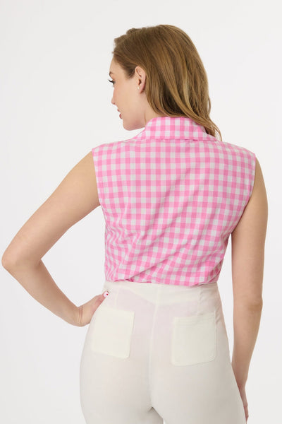 Model wearing sleeveless cotton button-up blouse in white and pink gingham pattern with pointed notched collar. Shown tucked into pants from back