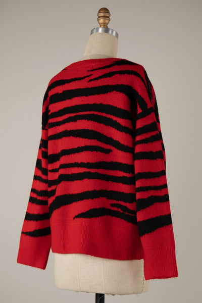 crew neck pullover sweater with drop shoulders in a black and bright red knit-in zebra print. Shown from the back