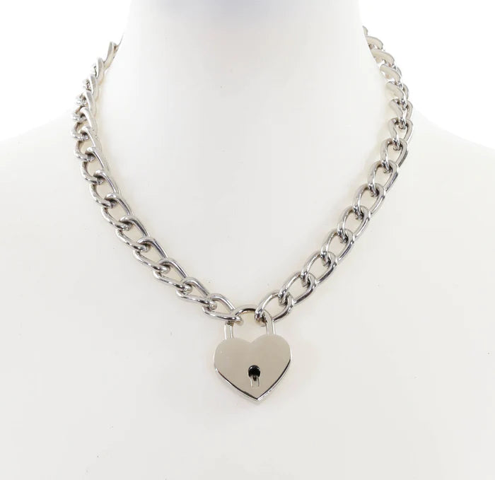 20” silver metal link chain with a 1” heart-shaped padlock in a shiny silver finish. Key on a split key ring is attached to the lock for opening and closing the padlock