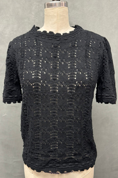 black short sleeve cotton blend knit pullover sweater with openwork grid pattern and pointelle details, round scalloped neckline, cuffs, and bottom band. Sleeves are slightly puffed. Shown from the front on a dress form