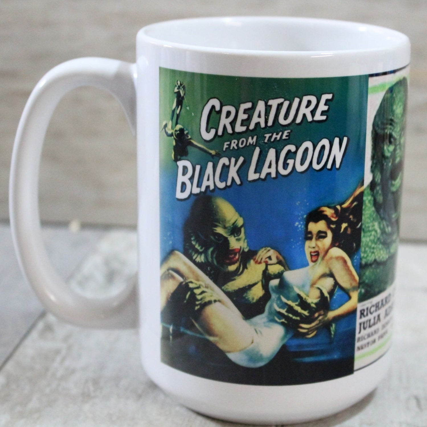 White ceramic mug with printed collage in full color of illustrated movie posters for Creature From The Black Lagoon. Seen from side