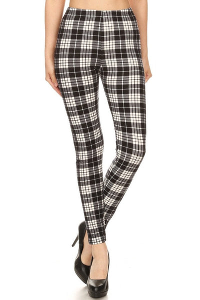 High-waist leggings in a black and cream plaid print. Shown on a model from a front angle