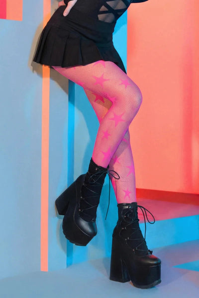 neon pink fishnet tights with allover knit-in multi-size five-pointed stars design, shown on a model