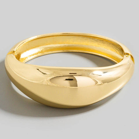 gold metal hinged bangle with asymmetrical rounded front