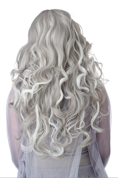 A woman wearing a long, wavy platinum white wig with dramatic dark eye makeup and a pale gray costume against a plain white background. Shown from the back