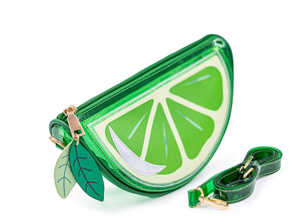 green vinyl purse shaped like slice of lime with zip closure top, zipper pulls shaped like green leaves, and removable matching strap. Shown from side with matching strap