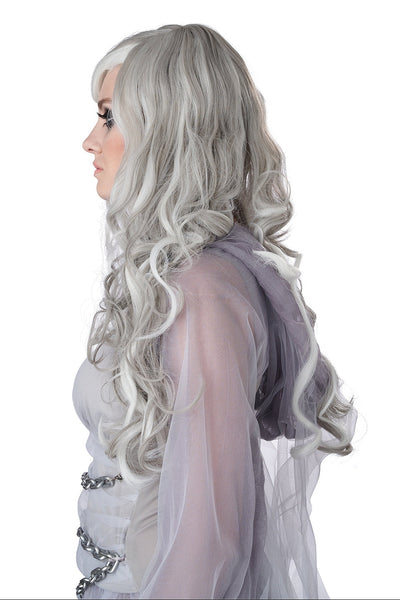 A woman wearing a long, wavy platinum white wig with dramatic dark eye makeup and a pale gray costume against a plain white background. Shown from the side