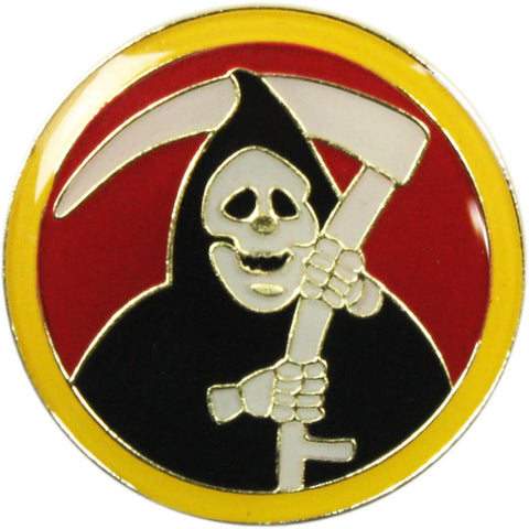 Round gold metal enamel pin of a grim reaper holding a scythe on a red background with a yellow border