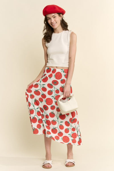 model wearing silk weave midi skirt with elastic waistband and off-white background sketch style red and green tomato pattern. Shown from front