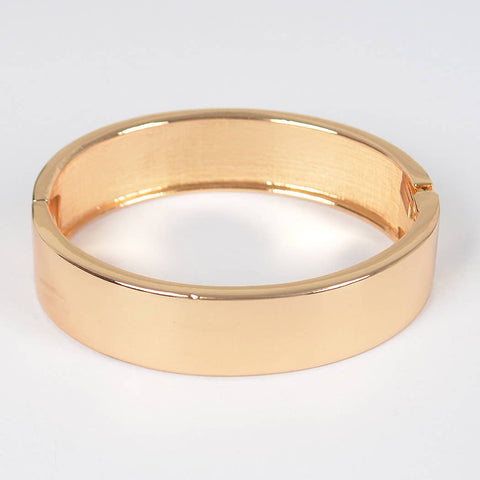 smooth shiny gold metal hinged bangle. Shown on its side