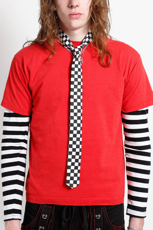 Model wearing cotton twill skinny tie in black and white checker pattern