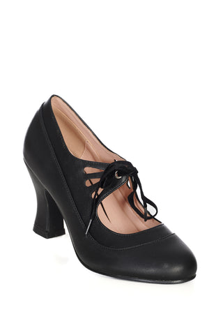 round-toed black faux-leather pump style shoe with a 3" heel height and  featuring teardrop cutout detail straps across the instep fastened with soft black velvet ribbon ties