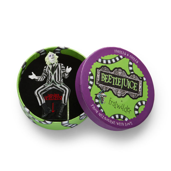 'Beetlejuice' character in his black and white striped suit sitting on his gravestone layered acrylic resin brooch, shown in illustrated round box packaging