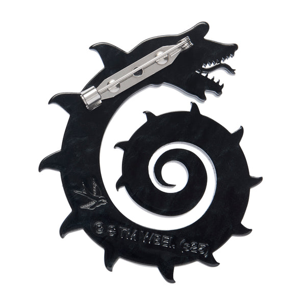 layered acrylic resin brooch of a coiled black and white striped Beetlejuice Sandworm, showing solid black back view with silver metal pin clasp