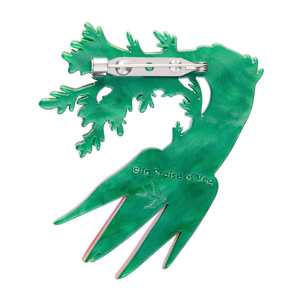 bunch of orange carrots with green tops layered acrylic resin brooch, showing green back with silver metal pin clasp