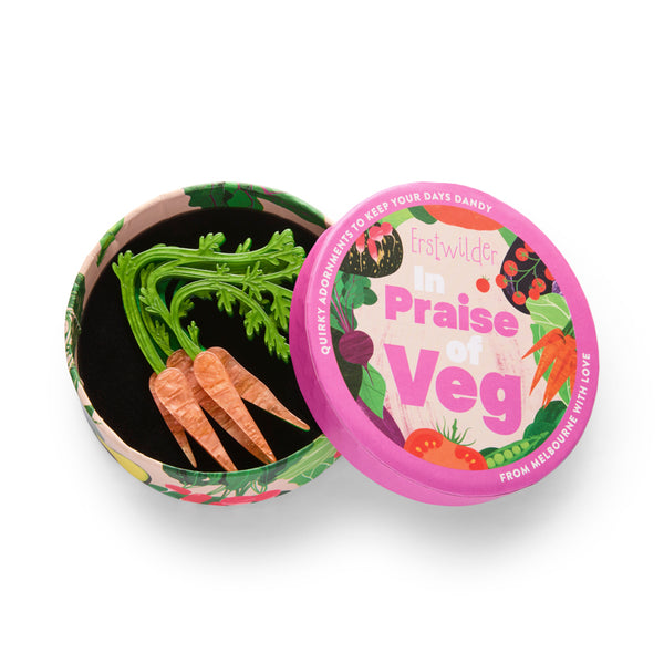 bunch of orange carrots with green tops layered acrylic resin brooch, shown in illustrated round box packaging