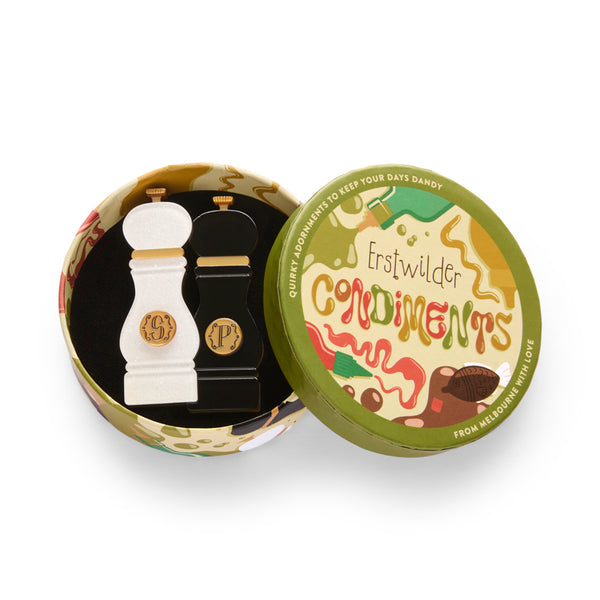 White and black layered acrylic resin pepper grinder set brooch with gold monogram, shown in illustrated round box packaging