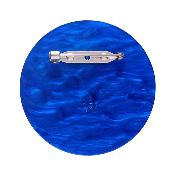 layered acrylic resin evil eye amulet brooch in blue, white, and glitter gold, showing solid blue backing layer with silver metal pin clasp