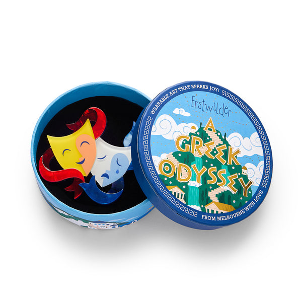 layered acrylic resin comedy and tragedy masks brooch, shown in illustrated round box packaging