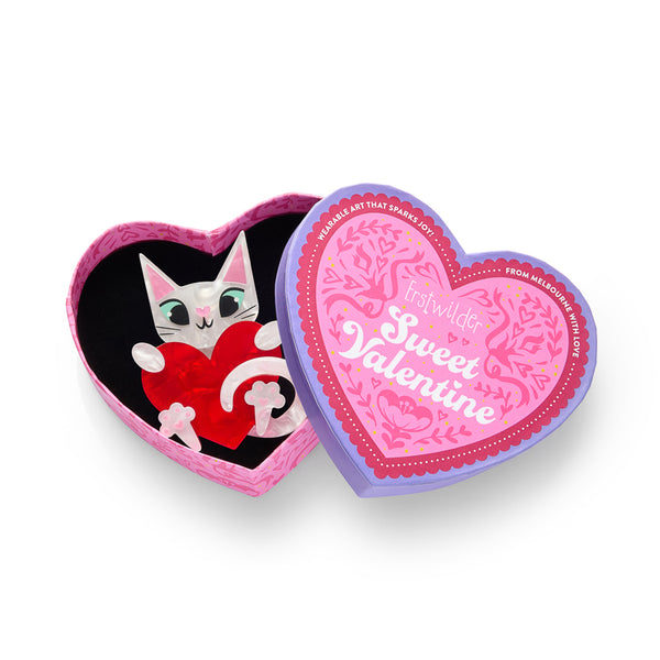 layered acrylic resin white cat holding a red heart brooch, shown in illustrated heart-shaped box packaging