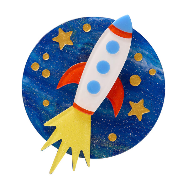 Colorful rocket ship against a space-themed background with stars and planets layered acrylic resin brooch