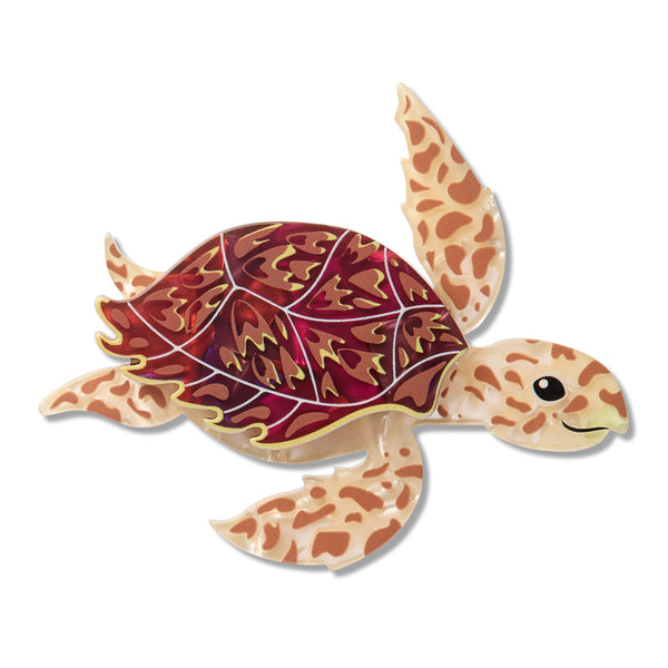 Colorful turtle-shaped resin brooch on a white background