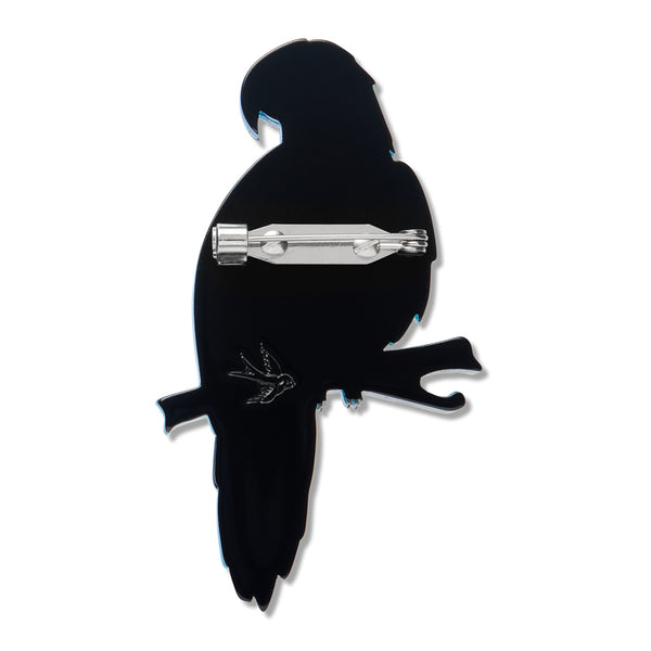 Blue parrot perched on a branch acrylic resin brooch, showing solid black back layer with silver metal pin clasp fastener