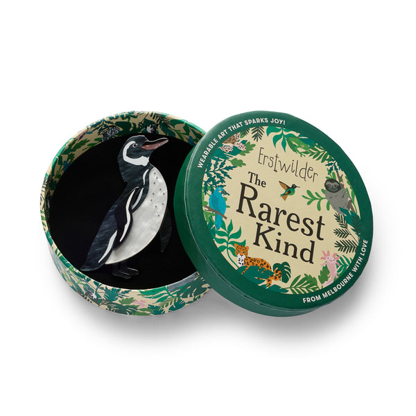 black and white acrylic resin penguin brooch shown in illustrated round box packaging