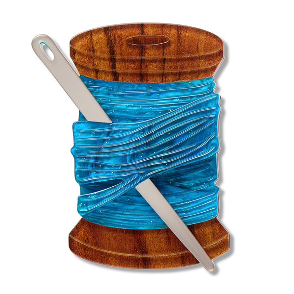 brown spool of blue thread with metallic silver needle acrylic resin brooch
