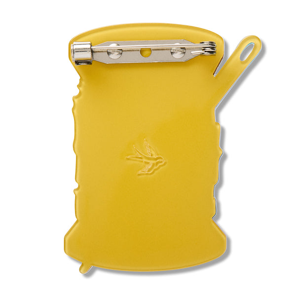 yellow back layer view of spool of thread shaped acrylic resin brooch