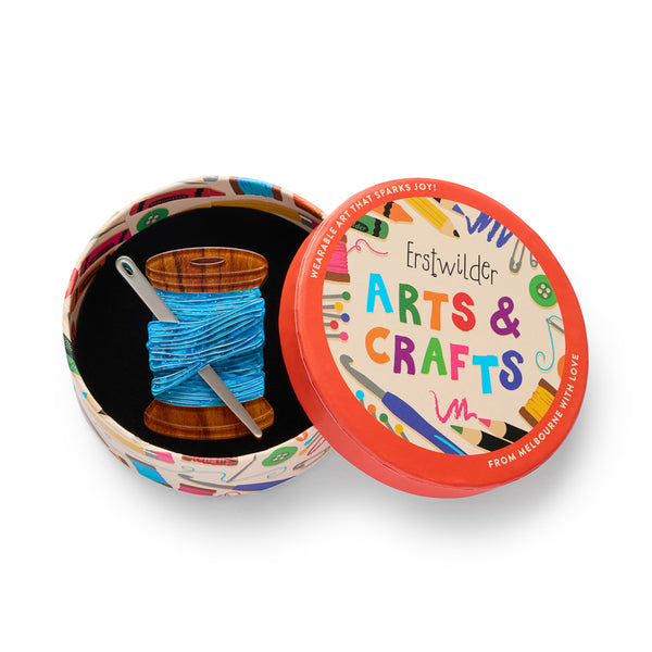 brown spool of blue thread with metallic silver needle acrylic resin brooch, shown in illustrated round box packaging