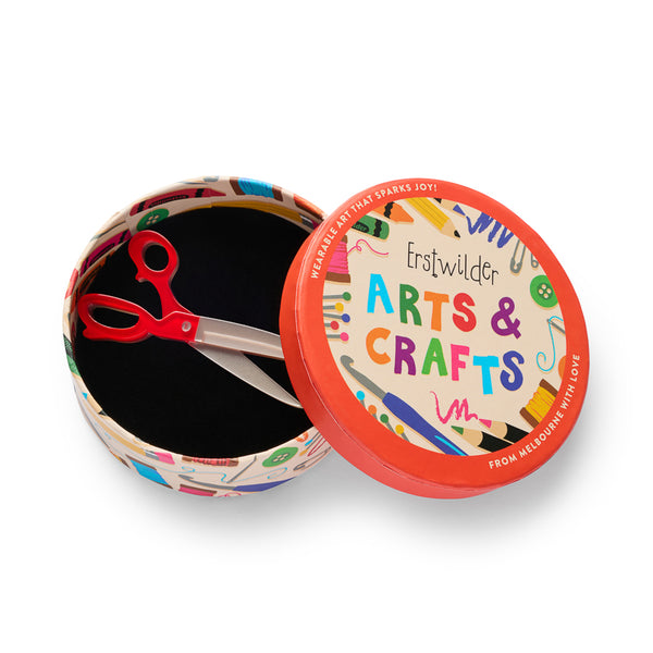 red and metallic silver acrylic resin scissors shaped brooch, shown in illustrated round box packaging