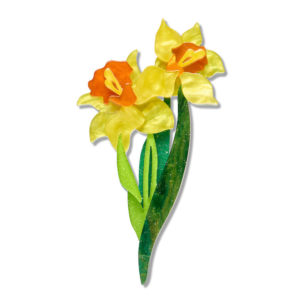 acrylic resin brooch depicting two yellow daffodils with orange centers and green leaves, shown on a plain white background.