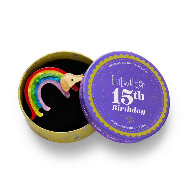 "Rainbow Ruff" rainbow striped arch bodied dog layered resin brooch, shown in illustrated round box packaging