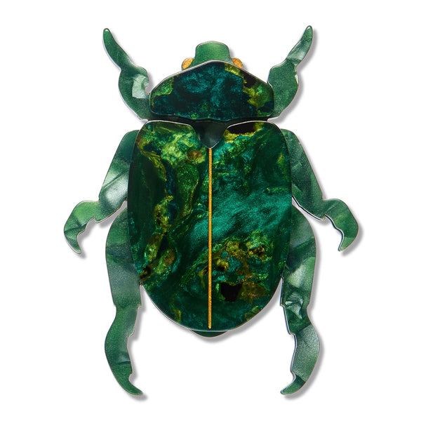 A beetle-shaped acrylic resin brooch in marbled greens with and a gold-colored central ridge, shown against a plain white background.