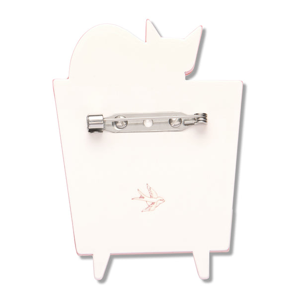 white resin back layer of a cat on a television-shaped brooch with silver metal pin clasp fastener