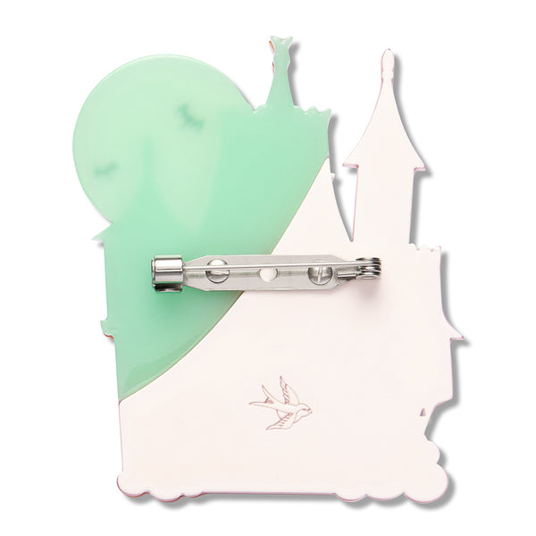 white and green resin back layer of a haunted house-shaped brooch with silver metal pin clasp fastener