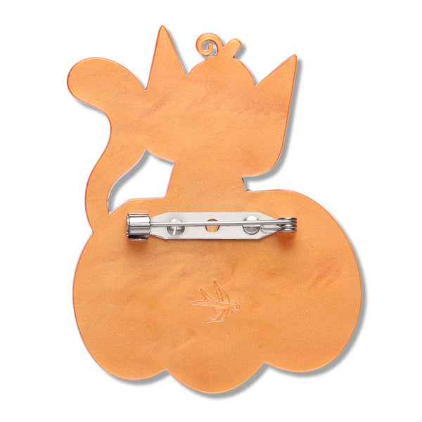orange resin back layer of a cat sitting in a pumpkin-shaped brooch with silver metal pin clasp fastener