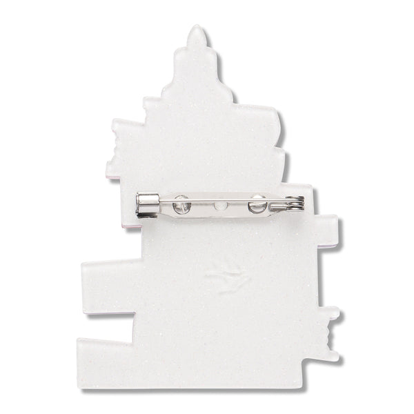 white resin back layer of a stack of books-shaped brooch with silver metal pin clasp fastener