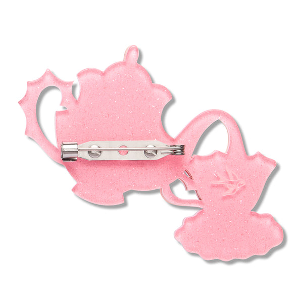 glitter pink resin back layer of a teapot and teacup-shaped brooch with silver metal pin clasp fastener
