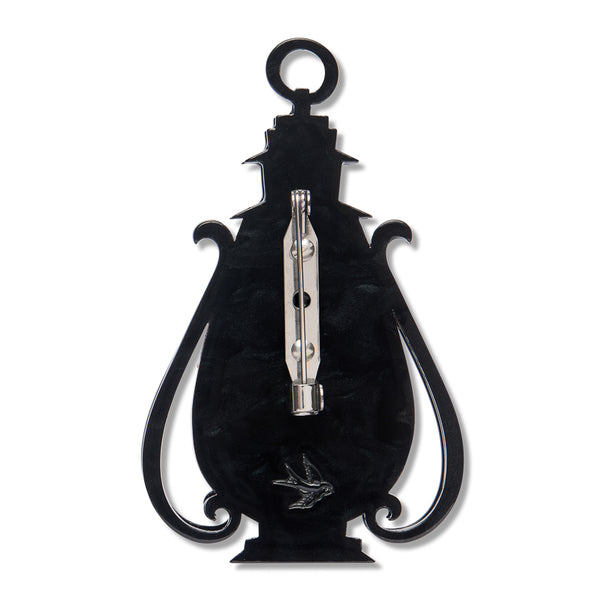 black resin back layer of a lantern-shaped brooch with silver metal pin clasp fastener