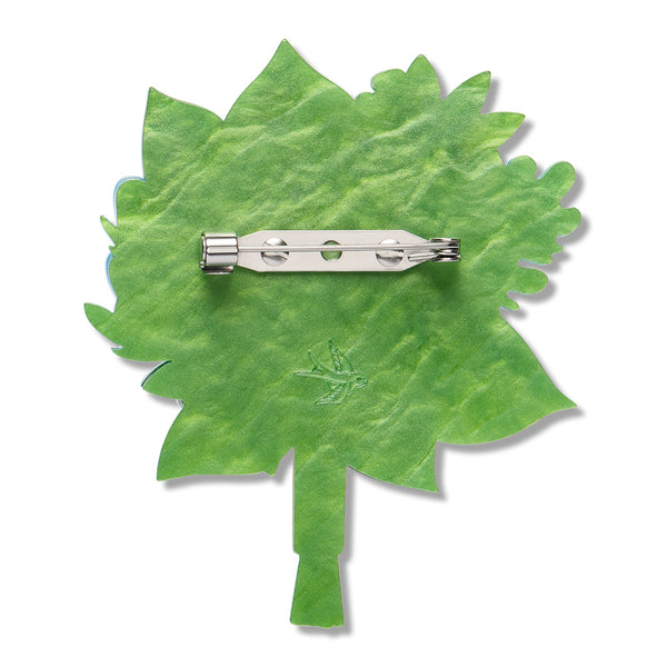 solid green back layer of layered acrylic resin floral bouquet brooch with silver metal pin clasp